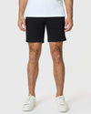 7 Black Classic Twill Shorts on model with tattoos, white sneakers.