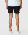 7 Black Classic Twill Shorts, worn with white sneakers, hem visible.