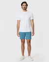 Model in 7 Harbor Classic Twill Shorts and white t-shirt.