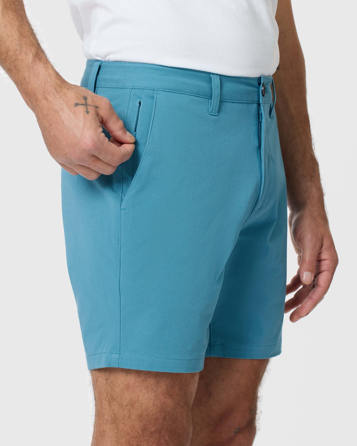 Person wearing 7 Harbor Classic Twill Shorts, tugging zippered pocket.