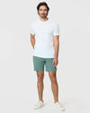 Man wearing 7 Moss Classic Twill Shorts with white T-shirt and sneakers.