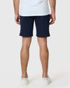 Back view of man wearing 7 Navy Classic Twill Shorts.