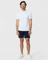 Man wearing 7 Navy Classic Twill Shorts with white T-shirt.