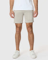 Man wearing 7 Sandstone Classic Twill Shorts, white sneakers.