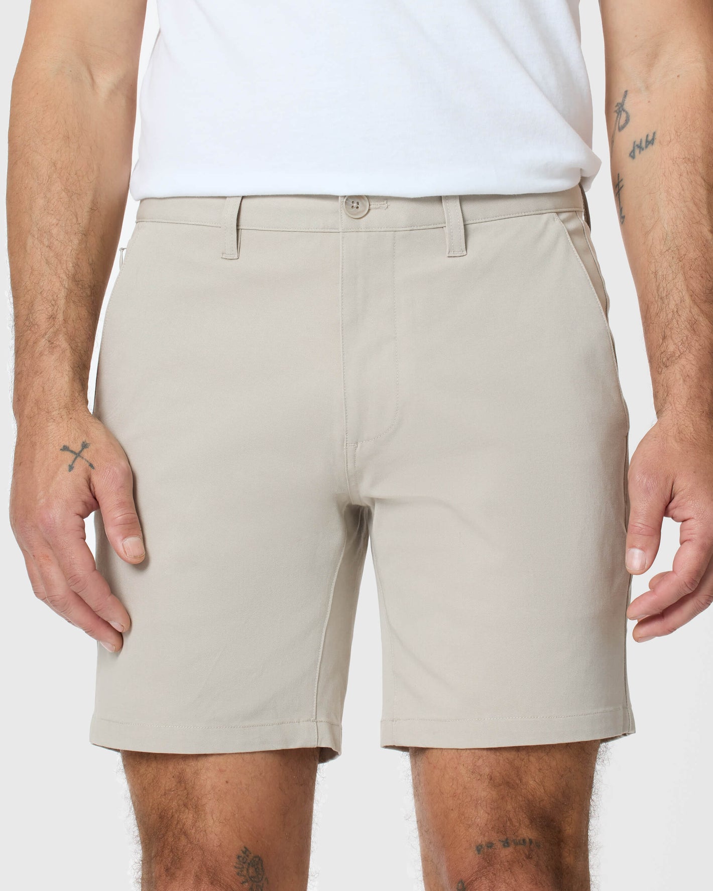 7 Sandstone Classic Twill Shorts on tattooed model's legs and forearms.