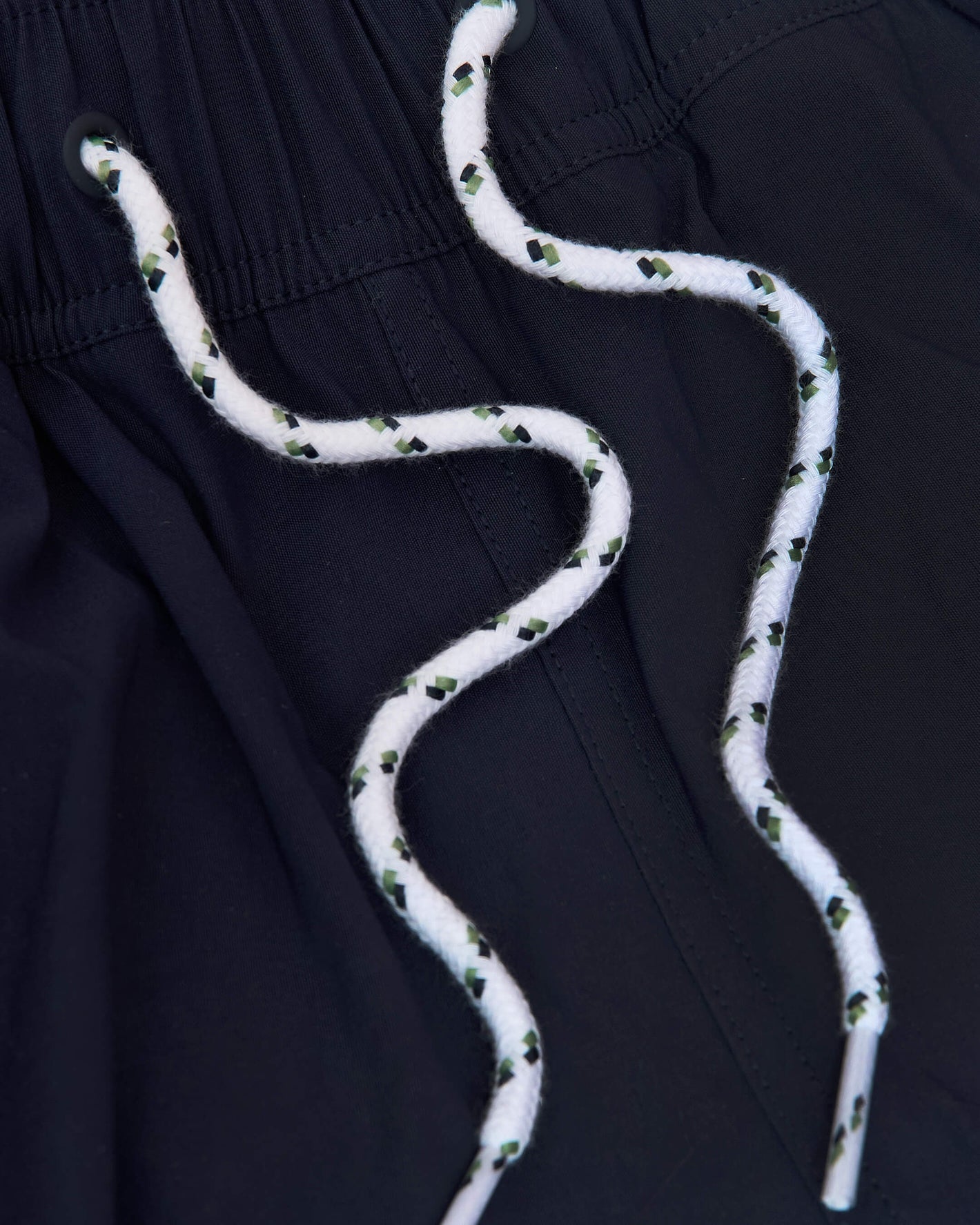 Navy Swim Trunk with elastic waistband and white drawcords.