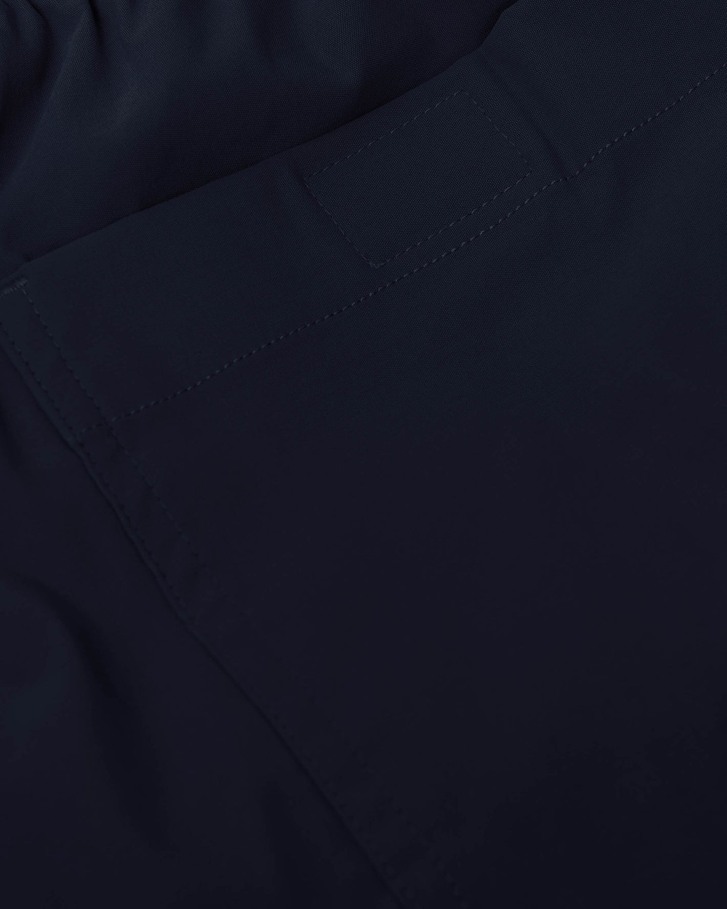 Navy Swim Trunk waistband with back pocket and Velcro tab detail.