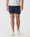Man wearing Navy Swim Trunk with white sneakers.