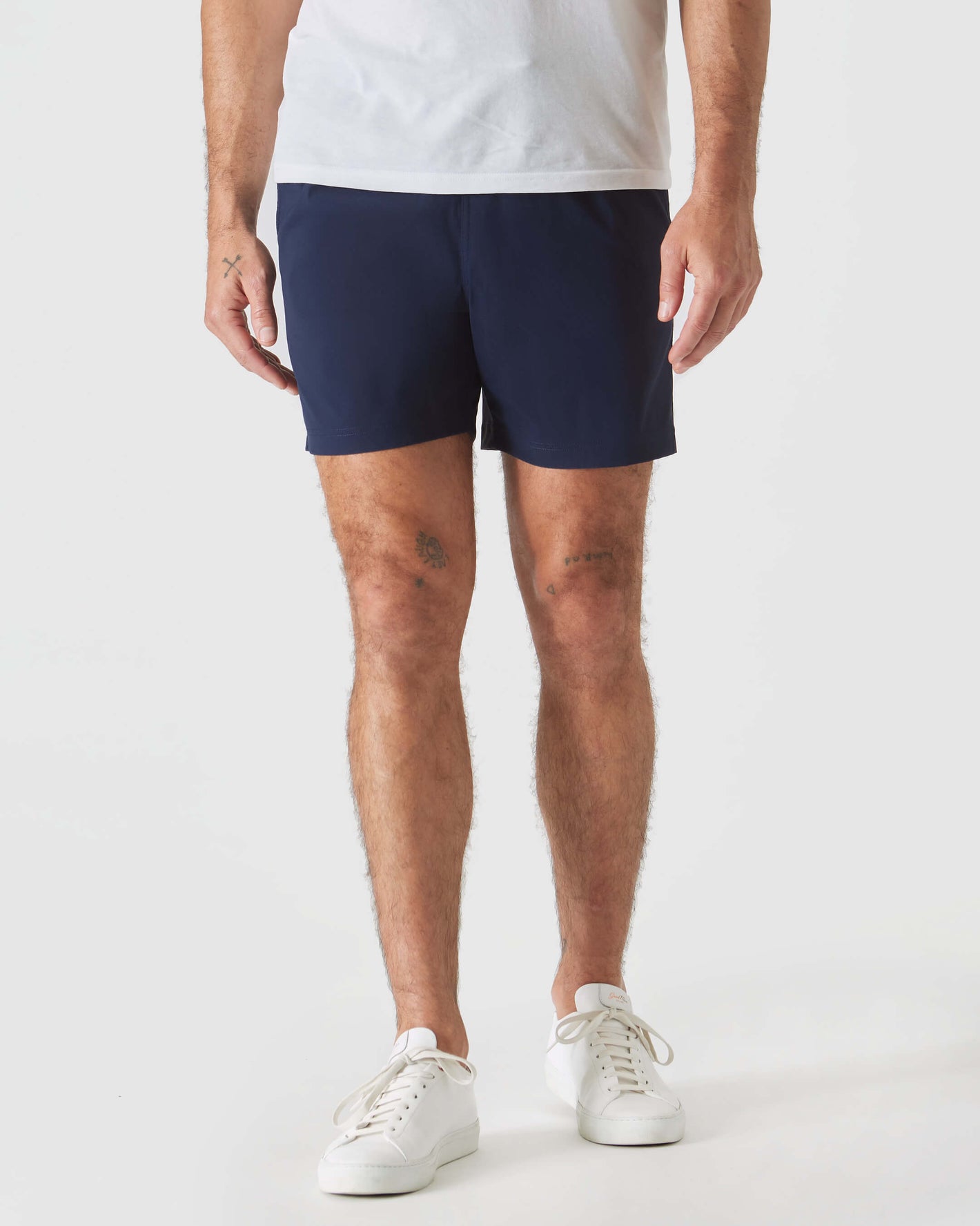 Man wearing Navy Swim Trunk with white sneakers.