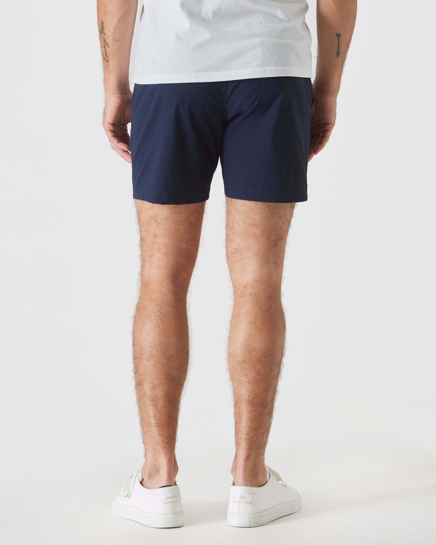 Navy Swim Trunk with elastic waist, visible tattoos on legs.