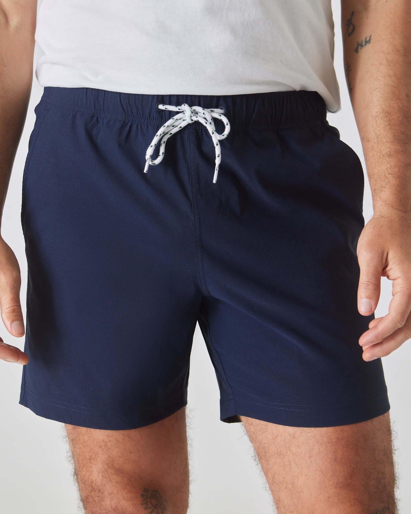 Navy Swim Trunk with elastic waistband and white drawstring.