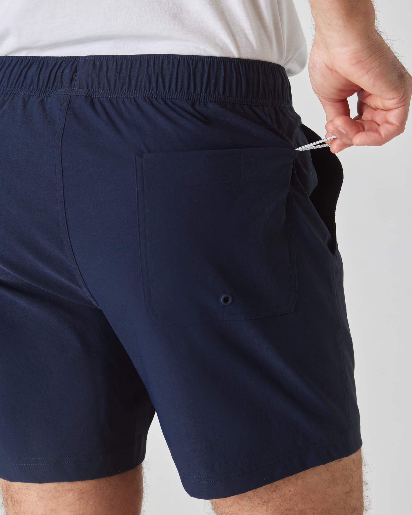 Navy Swim Trunk with elastic waist and drawstring in back pocket.