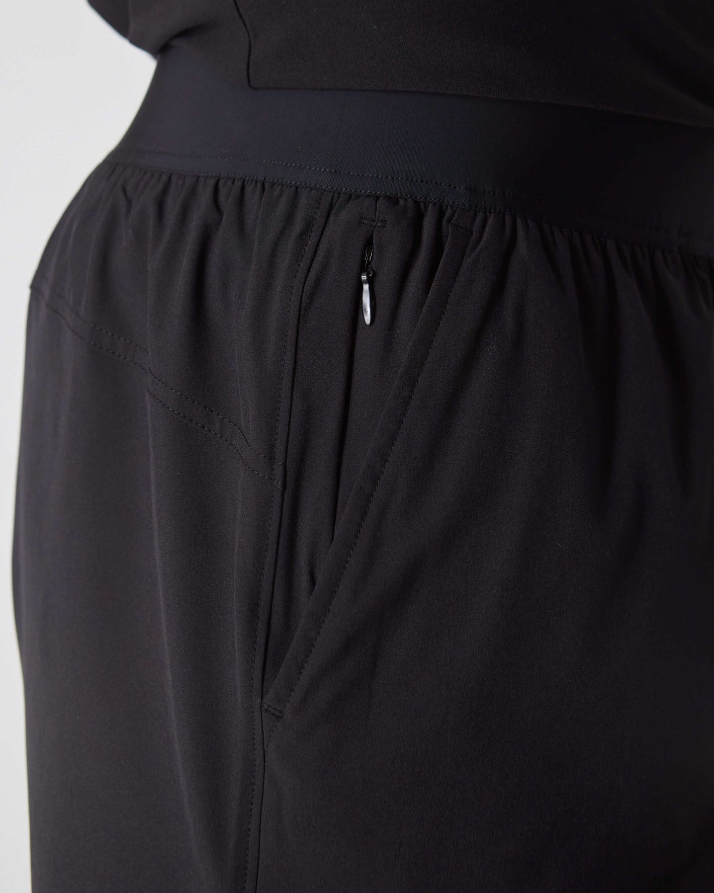 Black 2 In 1 Training Short with elastic waistband and side zip pocket.