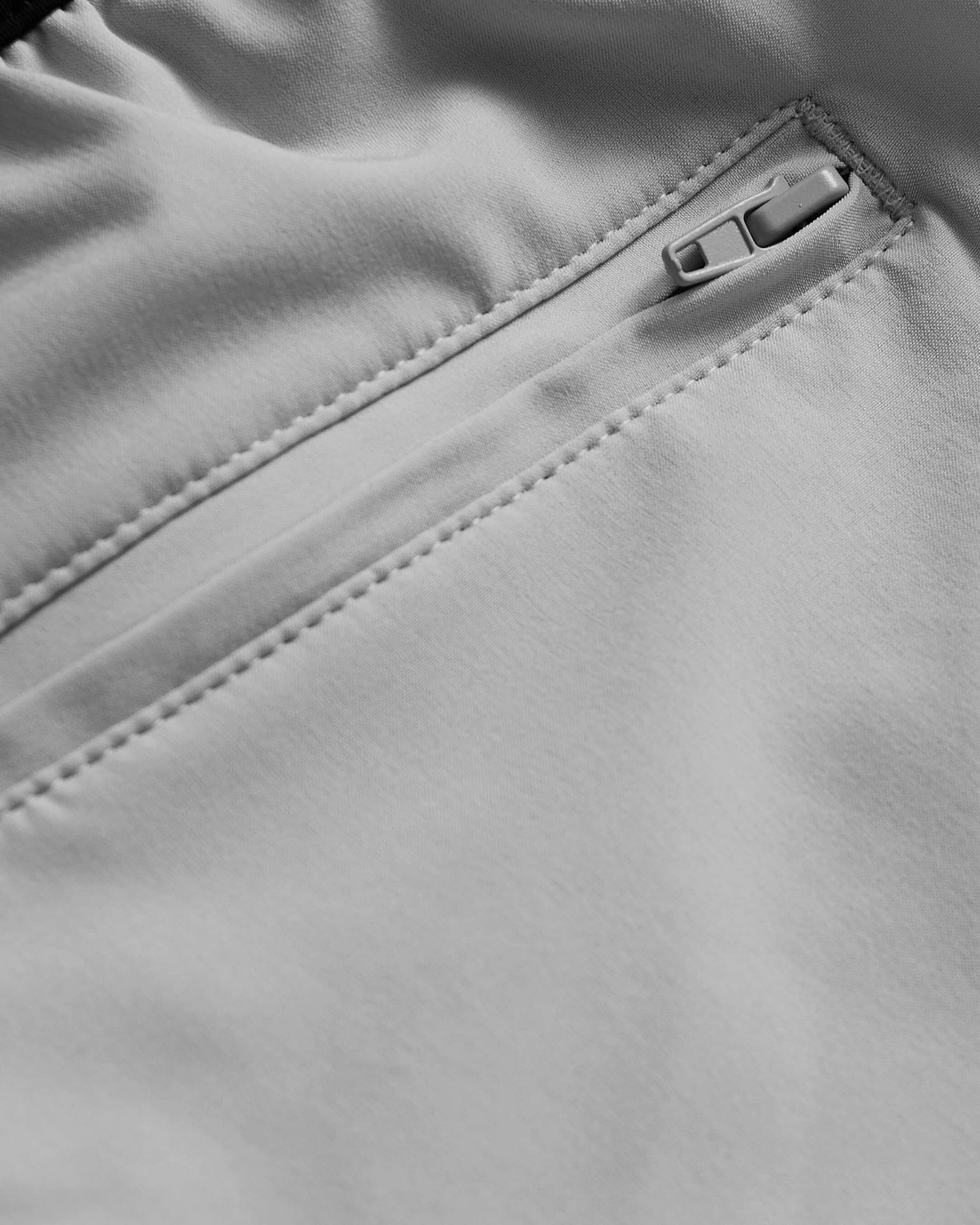 Steel 7 Active Training Short, close-up of zipper and seam detailing.