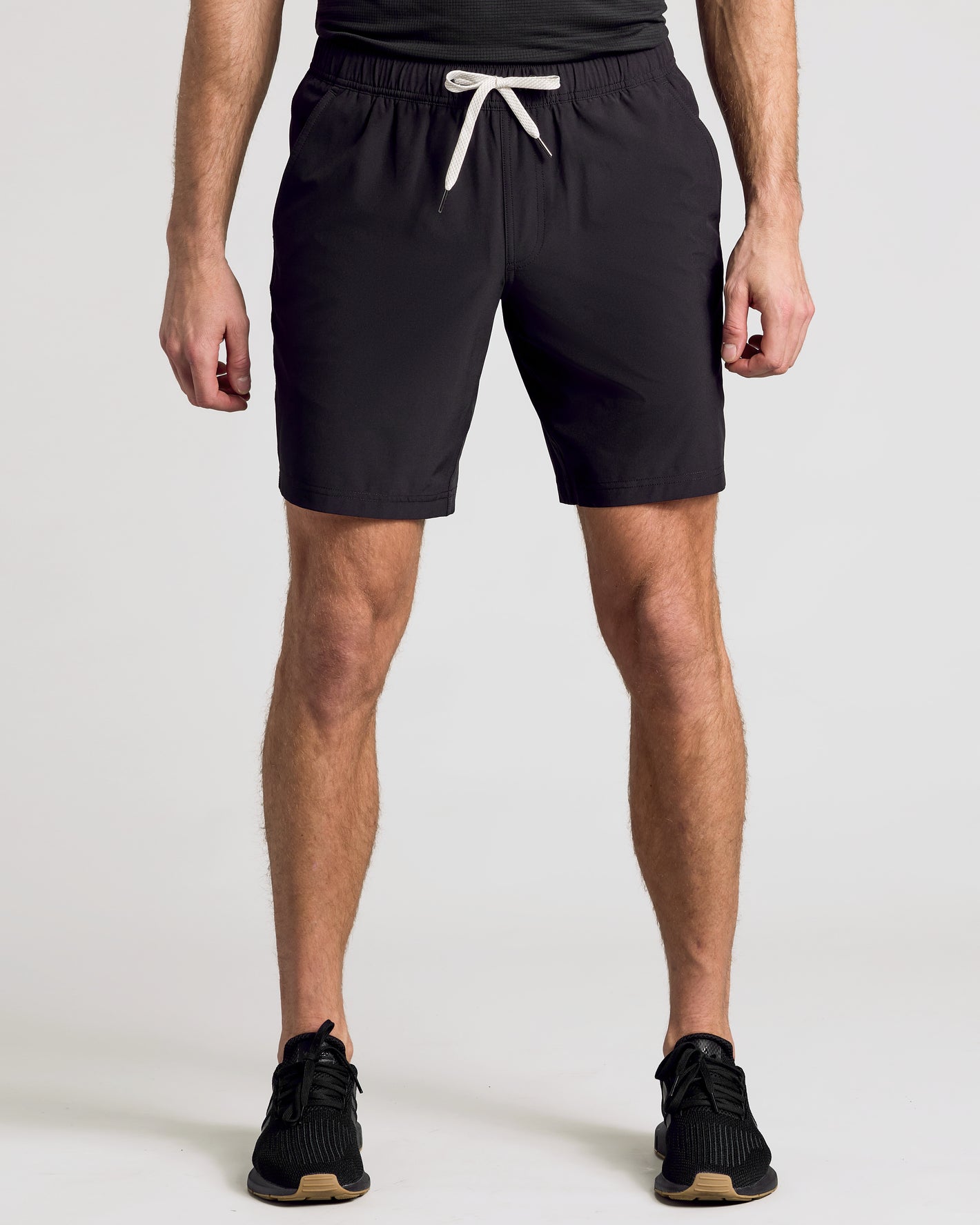 Man wearing 9 Black & Carbon Active Quick Dry Shorts, standing shoulder-width apart.