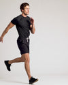 Man in Black 9 Active Quick Dry Shorts, mid-stride.