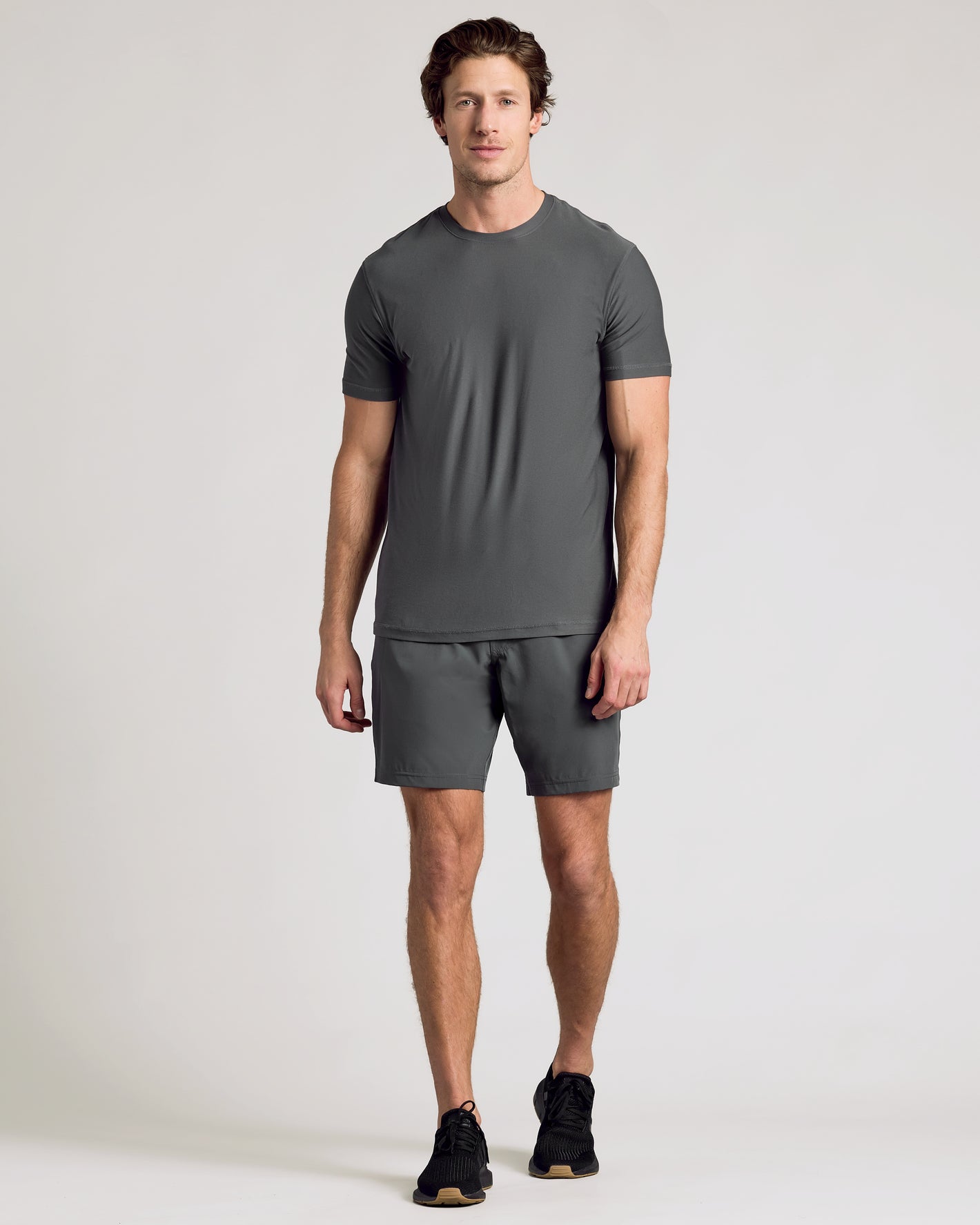 Man wearing Carbon 9 Active Quick Dry Shorts, showcasing athletic fit.