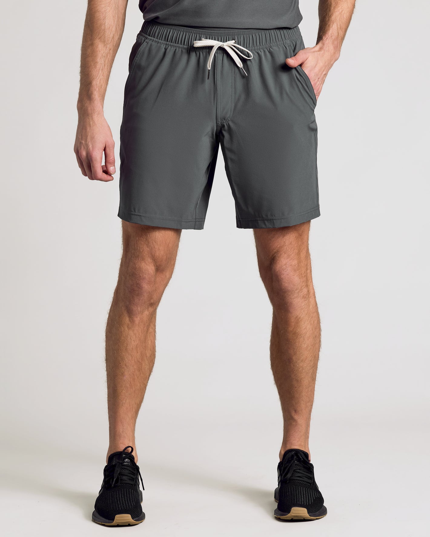 Man wearing 9 Black & Carbon Active Quick Dry Shorts, hands relaxed.