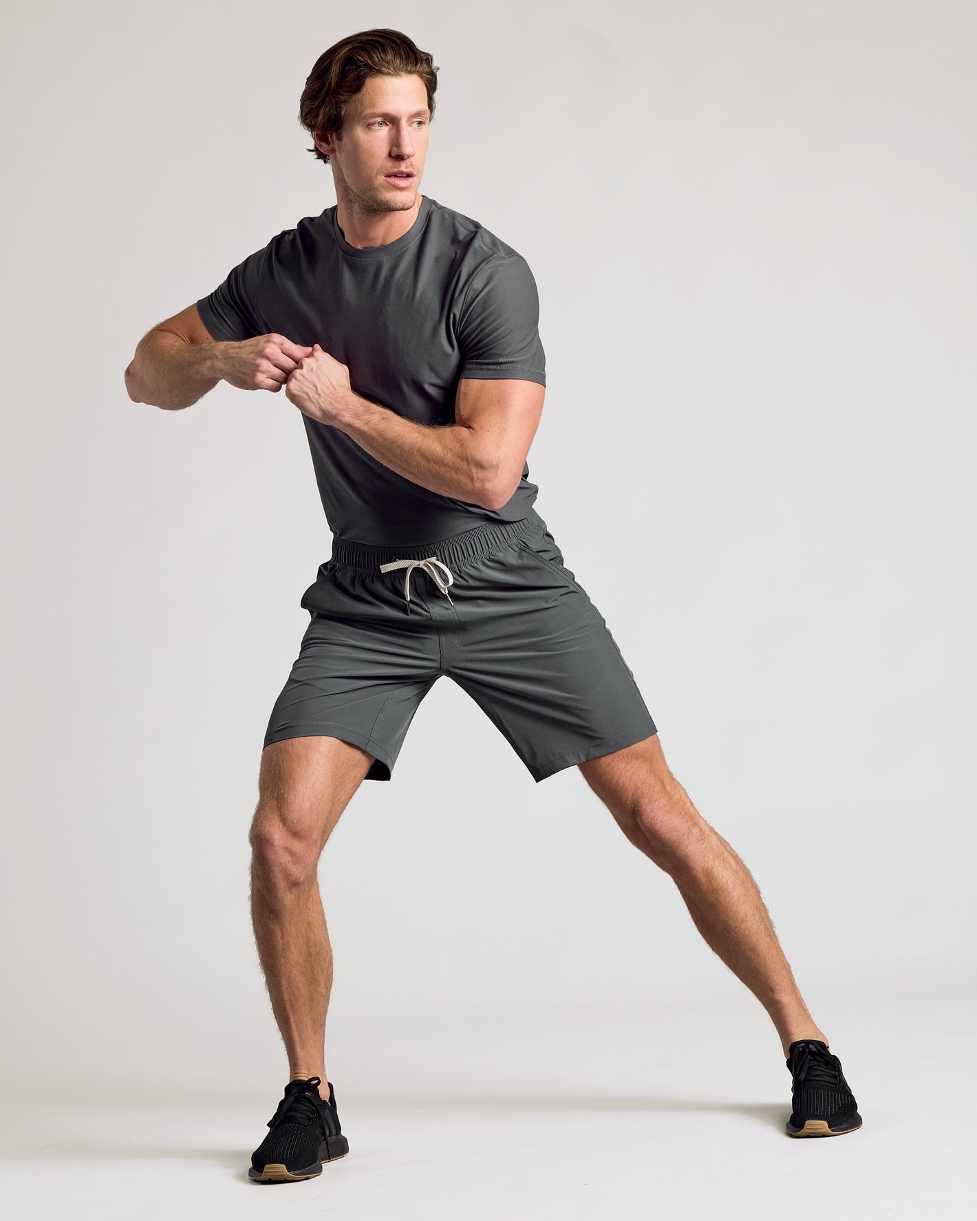Man demonstrating exercise in 9 All Carbon Active Quick Dry Shorts.