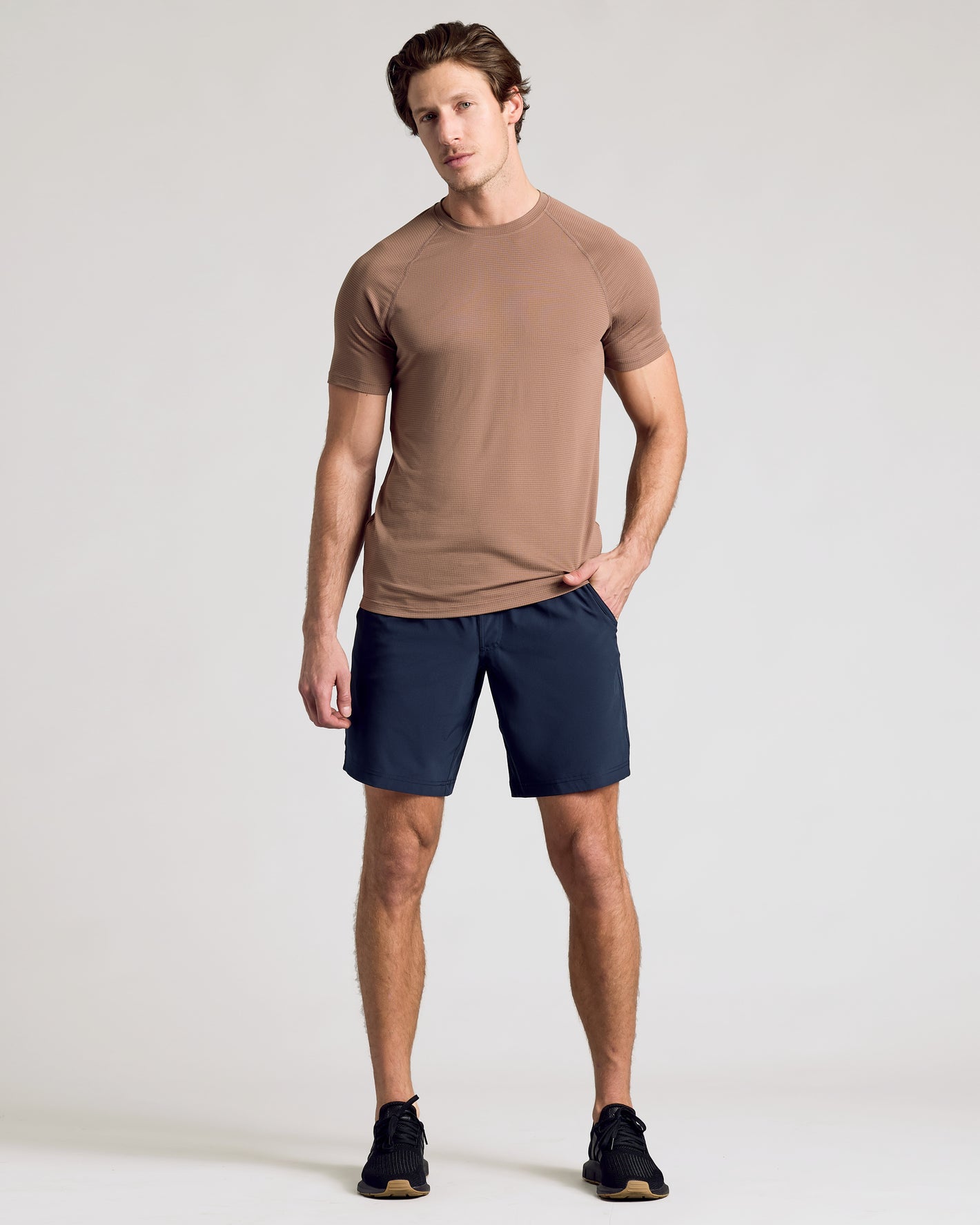 Young man wearing Navy 9 Active Quick Dry Shorts in athletic pose.