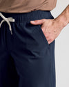 Person wearing Navy 9 Active Quick Dry Shorts with elastic waistband and drawcord.