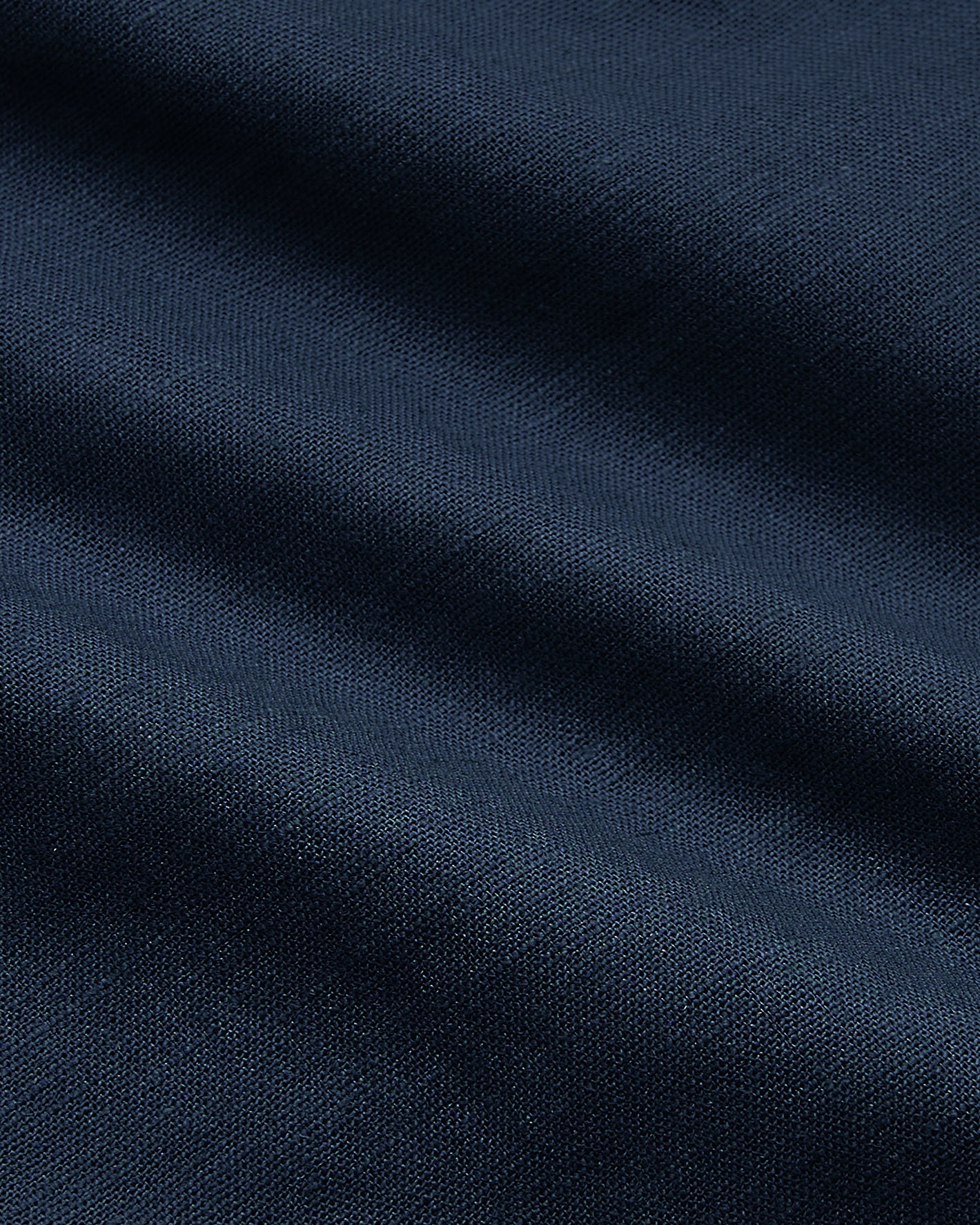 9 Navy Linen Shorts, close-up of draped, textured fabric.