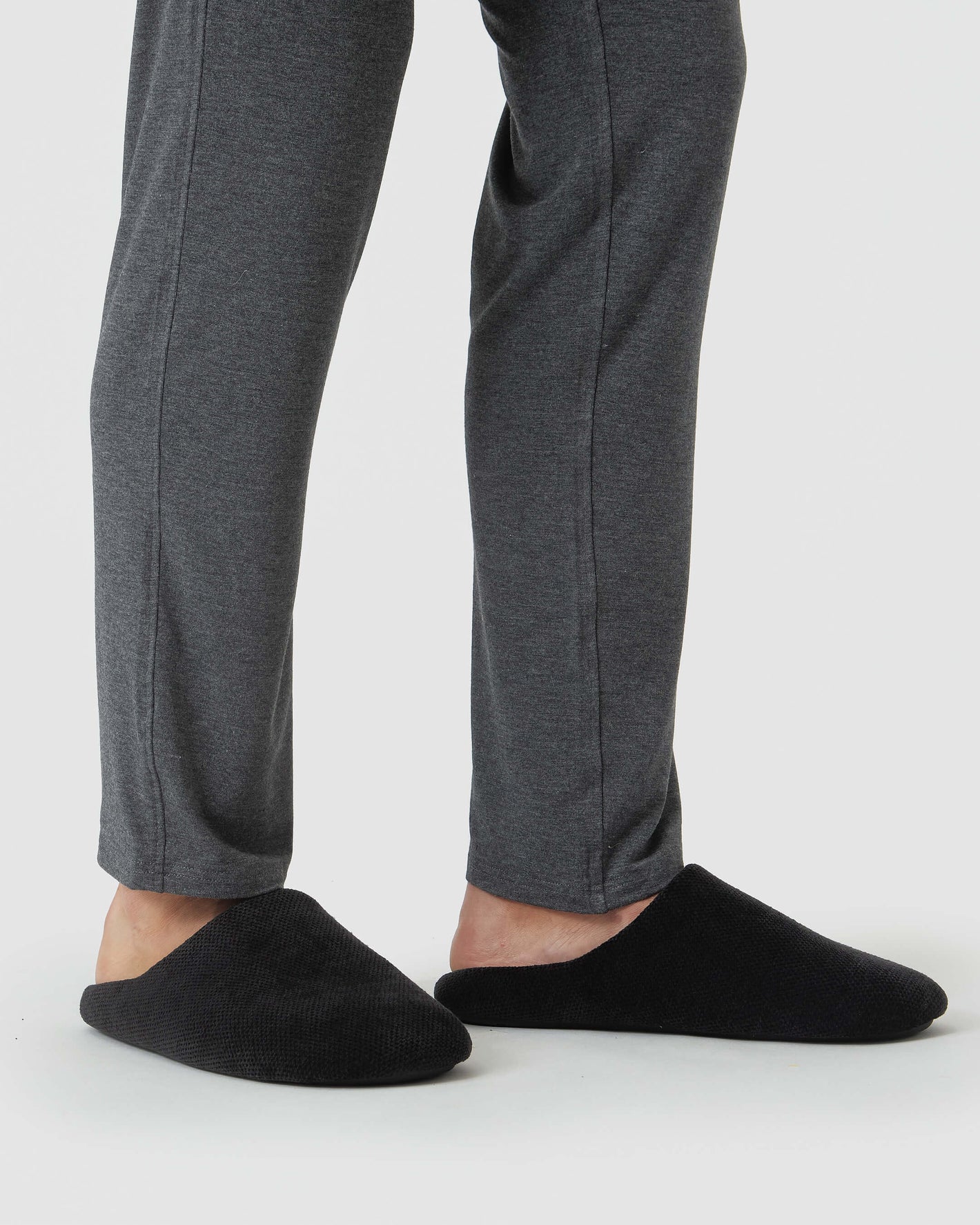 Black Slippers: Charcoal lounge pants with slip-on mules on white backdrop.