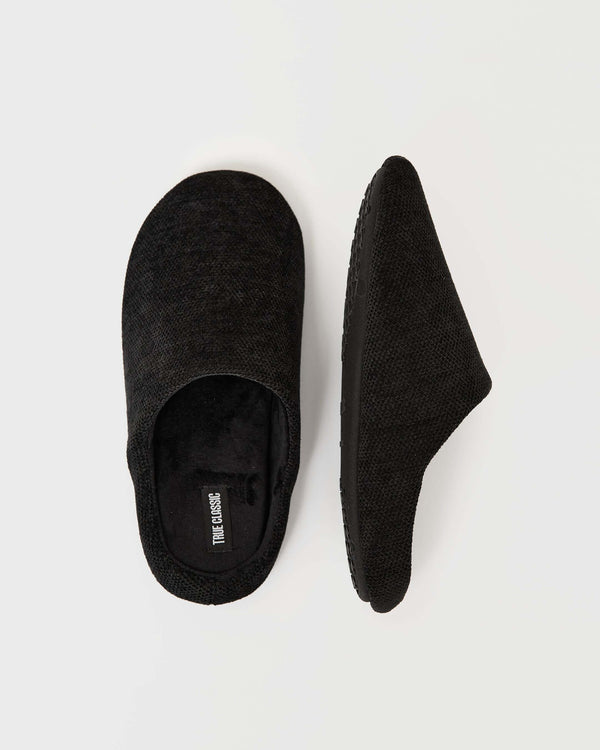 Black Slippers with True Classic label, top and profile view on light background.