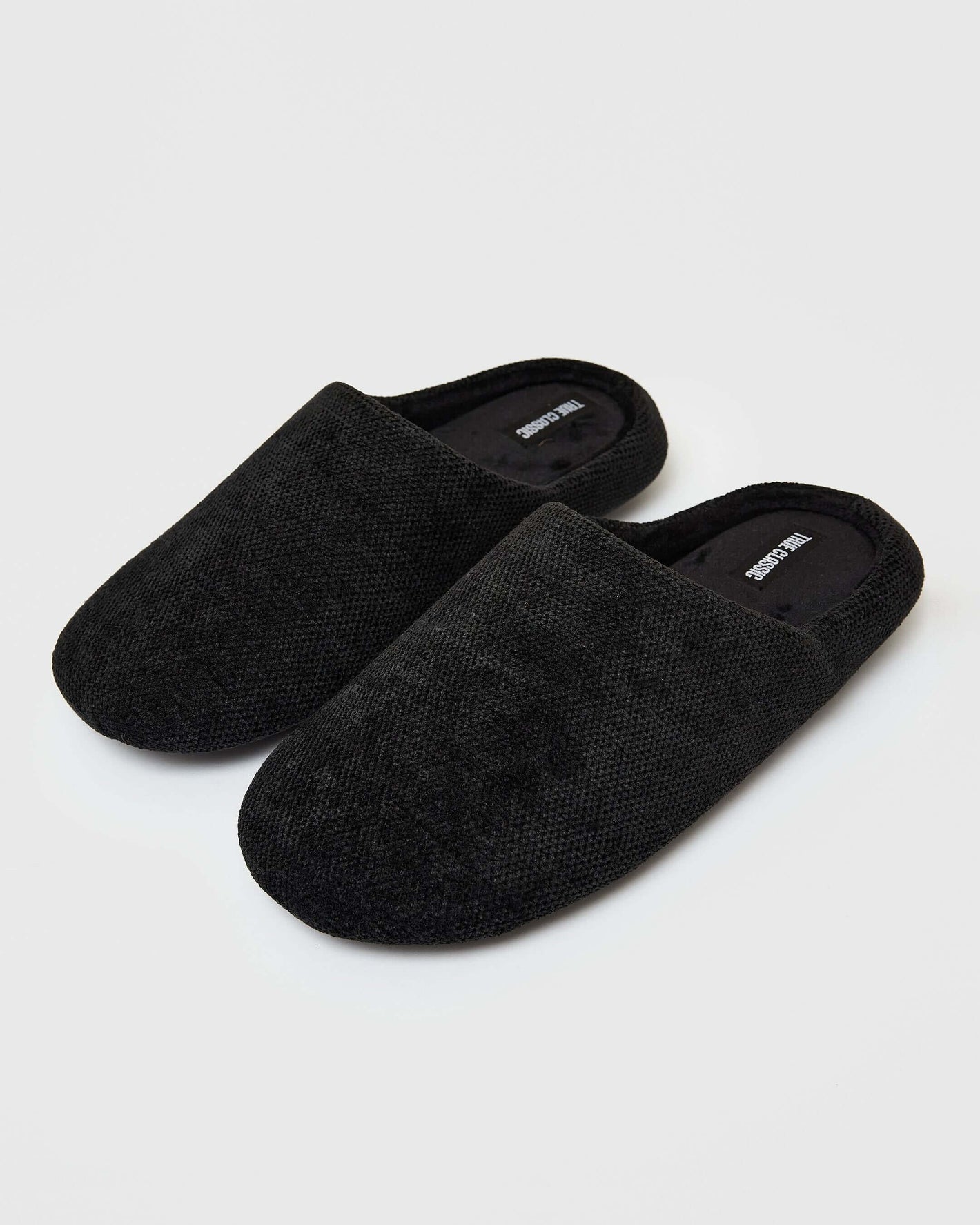 Black Slippers: all-black, textured slip-on mules with slide-free rubber soles.
