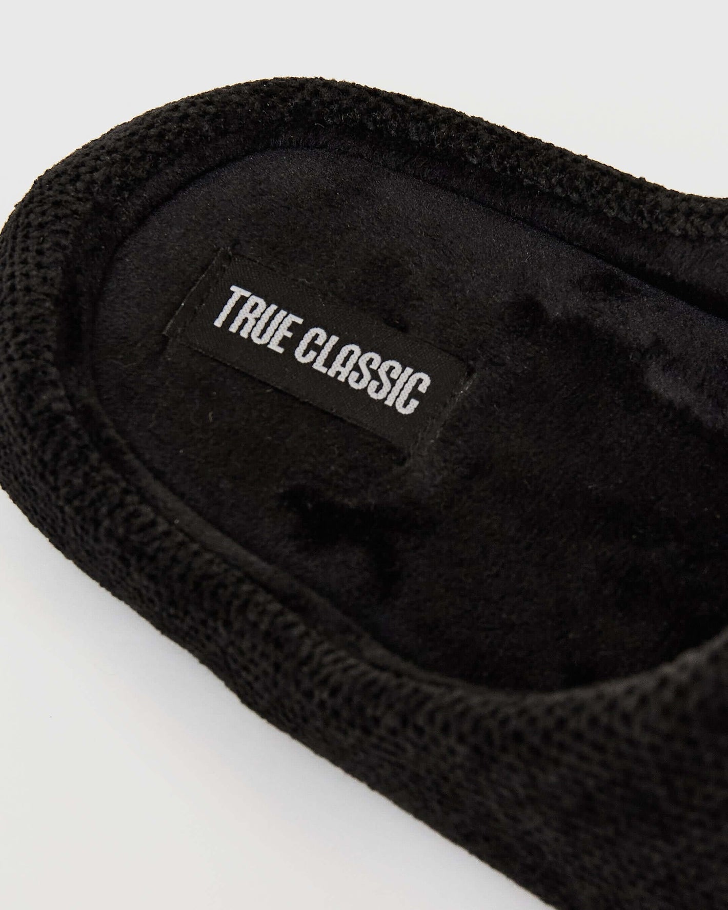 Black Slippers with knit-and-fleece headband, TRUE CLASSIC label visible.
