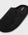 Black Slippers: Close-up of a textured knit slip-on with open back and rounded toe.