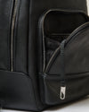 Premium Leather Backpack with pebbled texture, partially open front zippered pocket.
