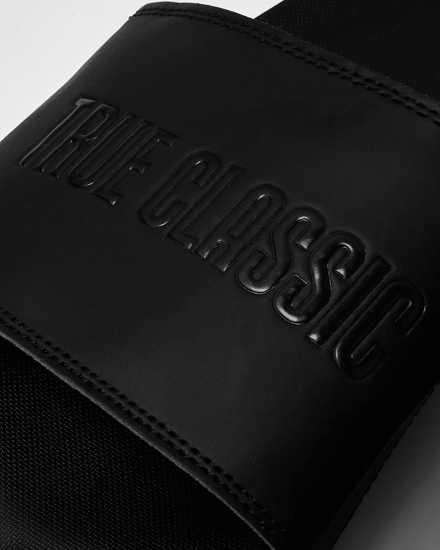 Black Comfort Slides with embossed TRUE GLASSING on the wide strap.