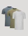 Three plain t-shirts in blue, green, and gray on a light gray background