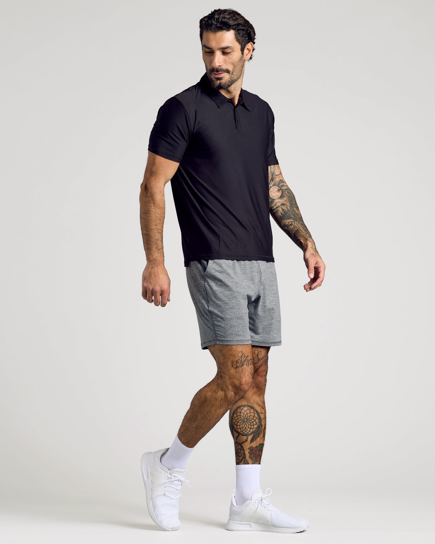 Man wearing Active Polo 10-Pack in black, showcasing athletic fit.