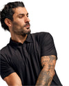 Man in Black Active Polo 6-Pack, showcasing tattoos on forearm.