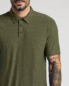 Close-up of a man wearing a Dark Heather Pear Active Polo 2.0 in olive green featuring a classic collar and button placket, showcasing a tattooed forearm for men's basics style.