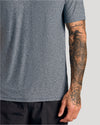 Heather Navy Short Sleeve Active Polo on tattooed arm and torso.