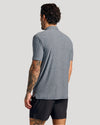 Man in Heather Navy Short Sleeve Active Polo, showcasing back view.