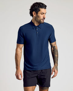 True ClassicMale model wearing The Staple Active Polo in navy with black shorts.