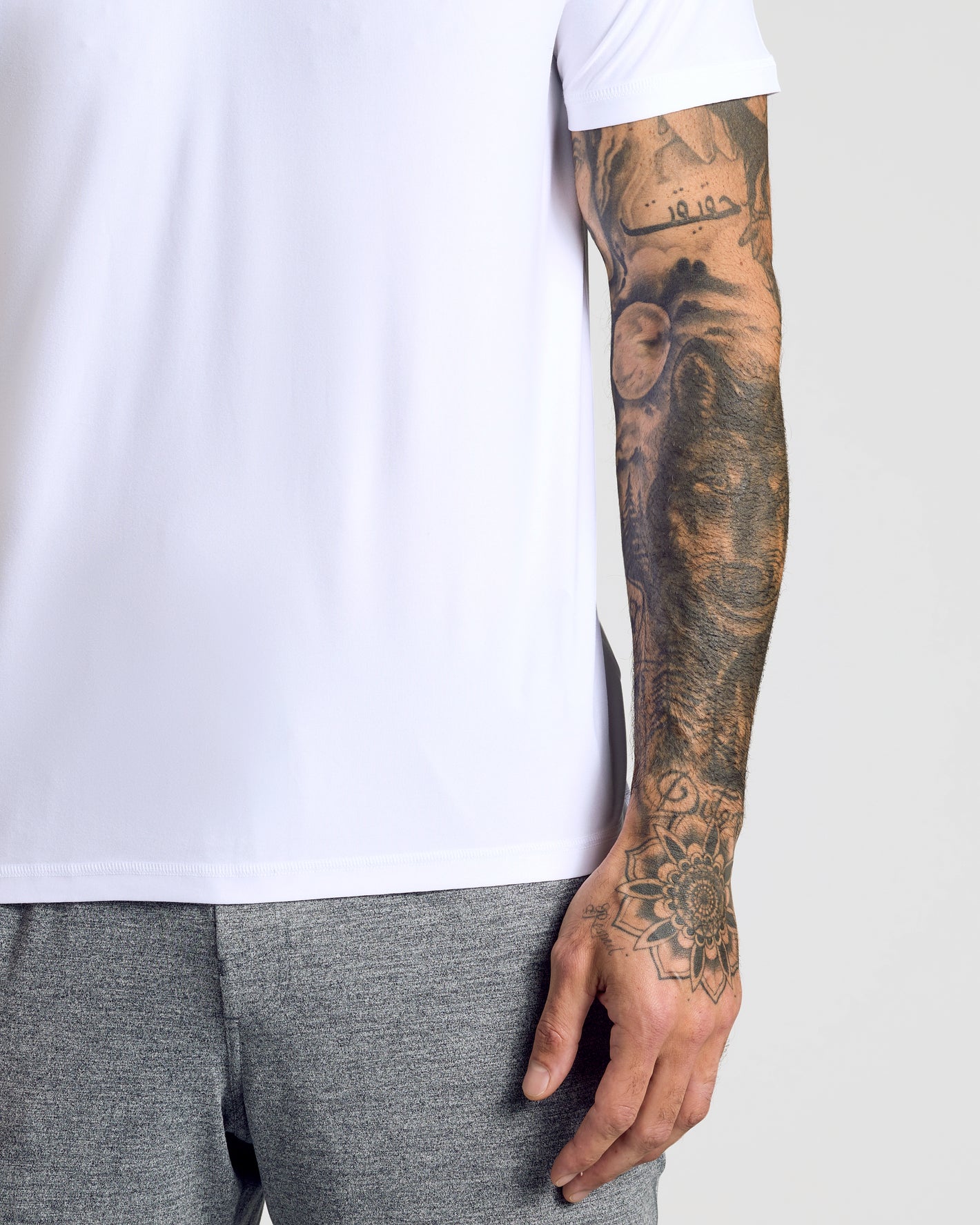 Active Polo 6-Pack showcased with tattooed arm and plain white T-shirt.