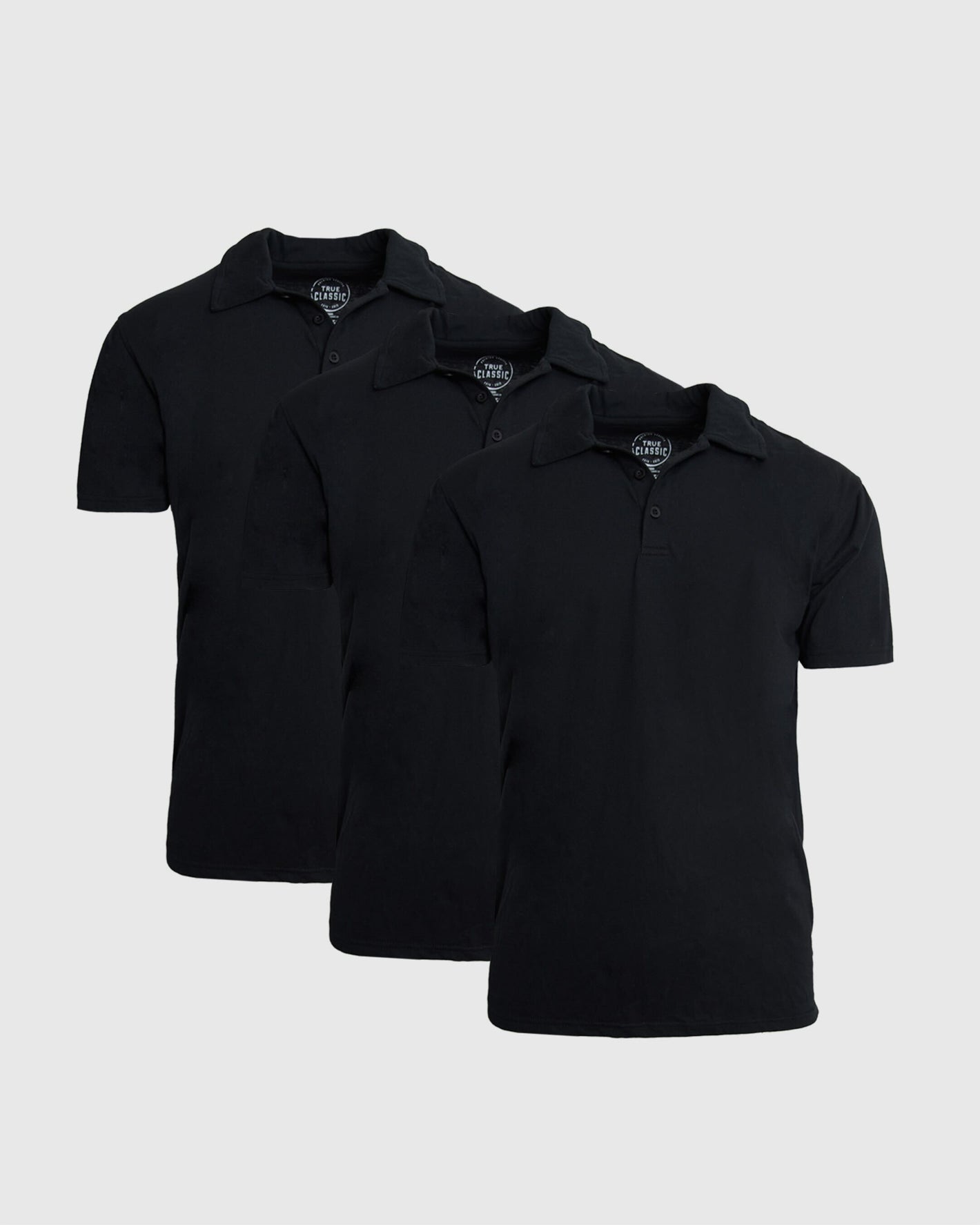 Black Classic Polo 3-Pack: Three identical short-sleeved, collared polo shirts.
