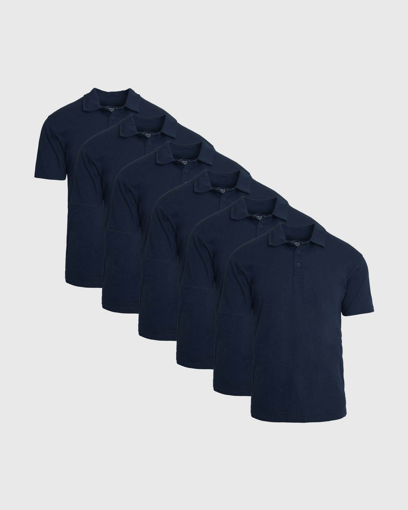 Classic Polo 6-Pack featuring six navy short sleeve polo shirts in a layered display with classic collars and button plackets for men's basics