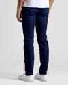 Indigo Rinse Slim Authentic Denim Jeans rear view with white sneakers.