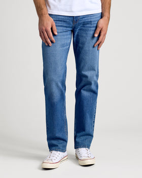 Medium Indigo Wash Straight Authentic Denim Jeans with white sneakers.