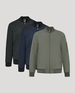 True ClassicThree bomber jackets in black, navy, and green on a light gray background