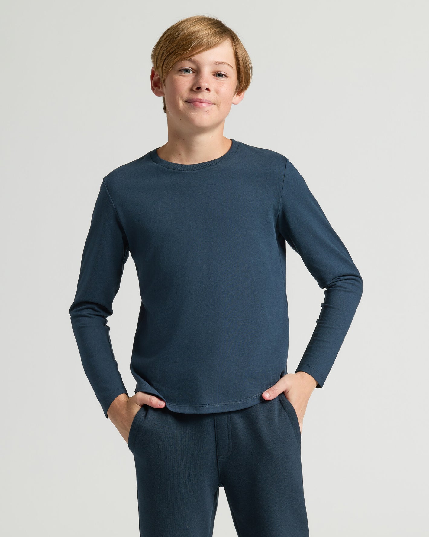 Boy wearing Boys' Navy Classic Long Sleeve Curved Hem Crew.