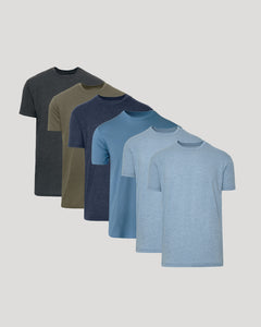 A set of five short-sleeve crewneck t-shirts in a gradient of colors, starting from dark gray, olive green, navy blue, medium blue, to light blue, arranged on a light gray background.