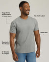 Man wearing a gray t-shirt with text highlighting features on a light gray background