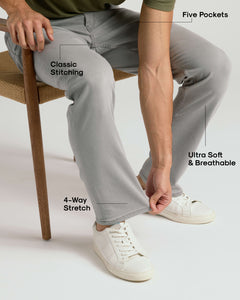 True ClassicMan wearing Medium Gray Wash Straight Comfort Stretch Jeans, demonstrating fabric's stretch.